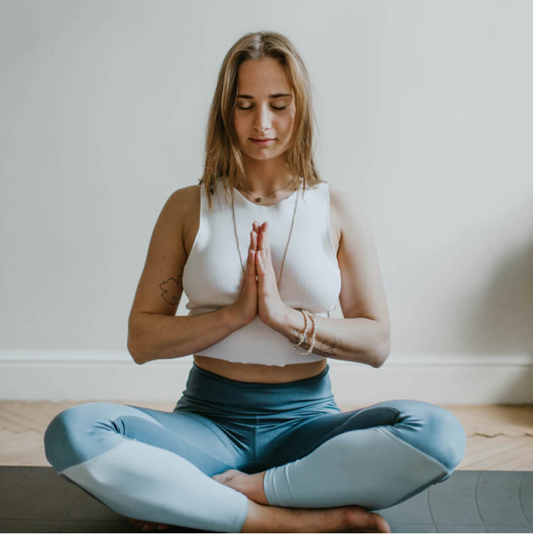 a woman meditating after ketamine therapy